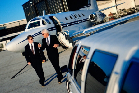 2 men walking near a plane